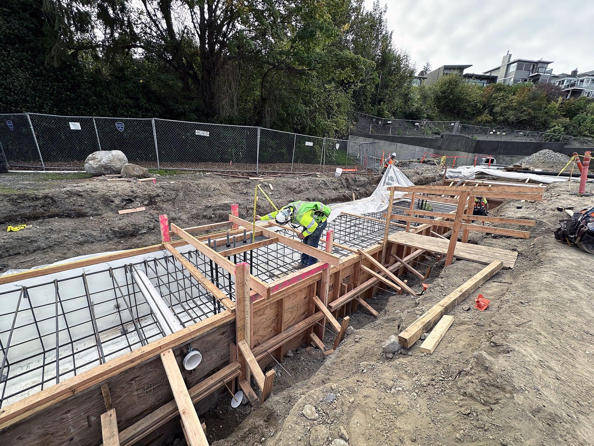 a person is working on a frame with rebar within a construction site